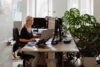 Employee in a green office with lots of plants